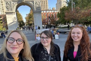 Caitlin, Emma and Rebecca taking a selfie in front of the Washington Square Arch