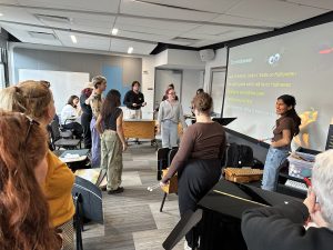 NYU students Jaime, leading a session with her classmates with a song called "On Halloween"