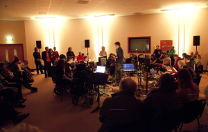 A wide shot of Digital Orchestra and some audience members at their first performance.