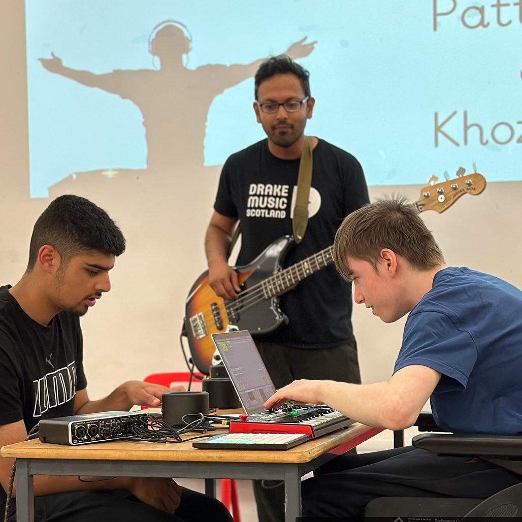 Two students at Kings Park jamming with Associate Musician Farhad Ahmed